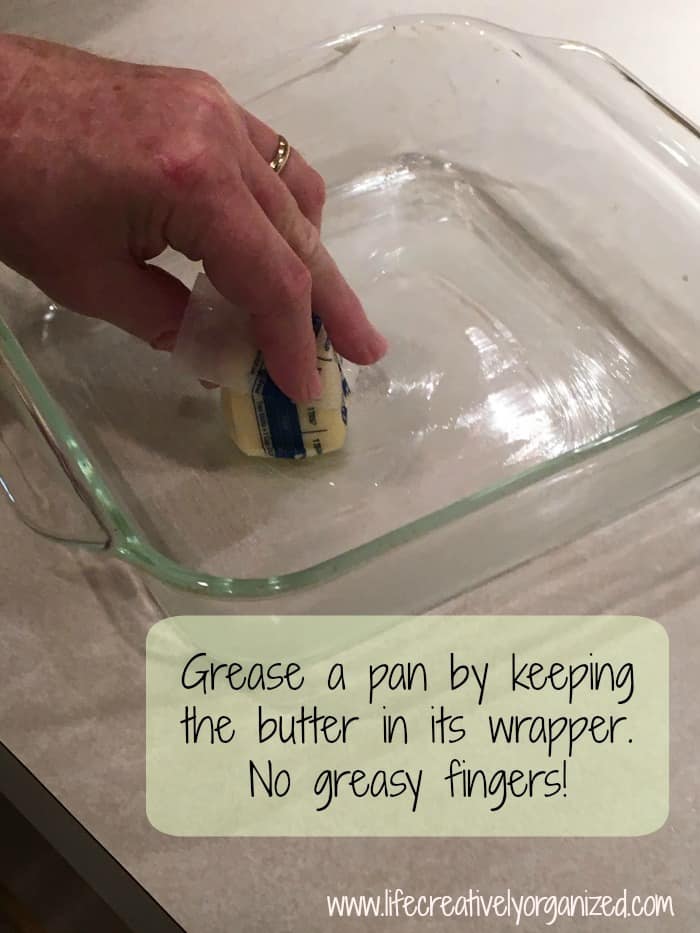 Grease a pan by keeping the butter in the wrapper as you hold it.  No greasy fingers!